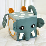 The Roommate Jungle animals soft Baby Activity Cube toy showing the side with the elephant face and the side with the mirror.