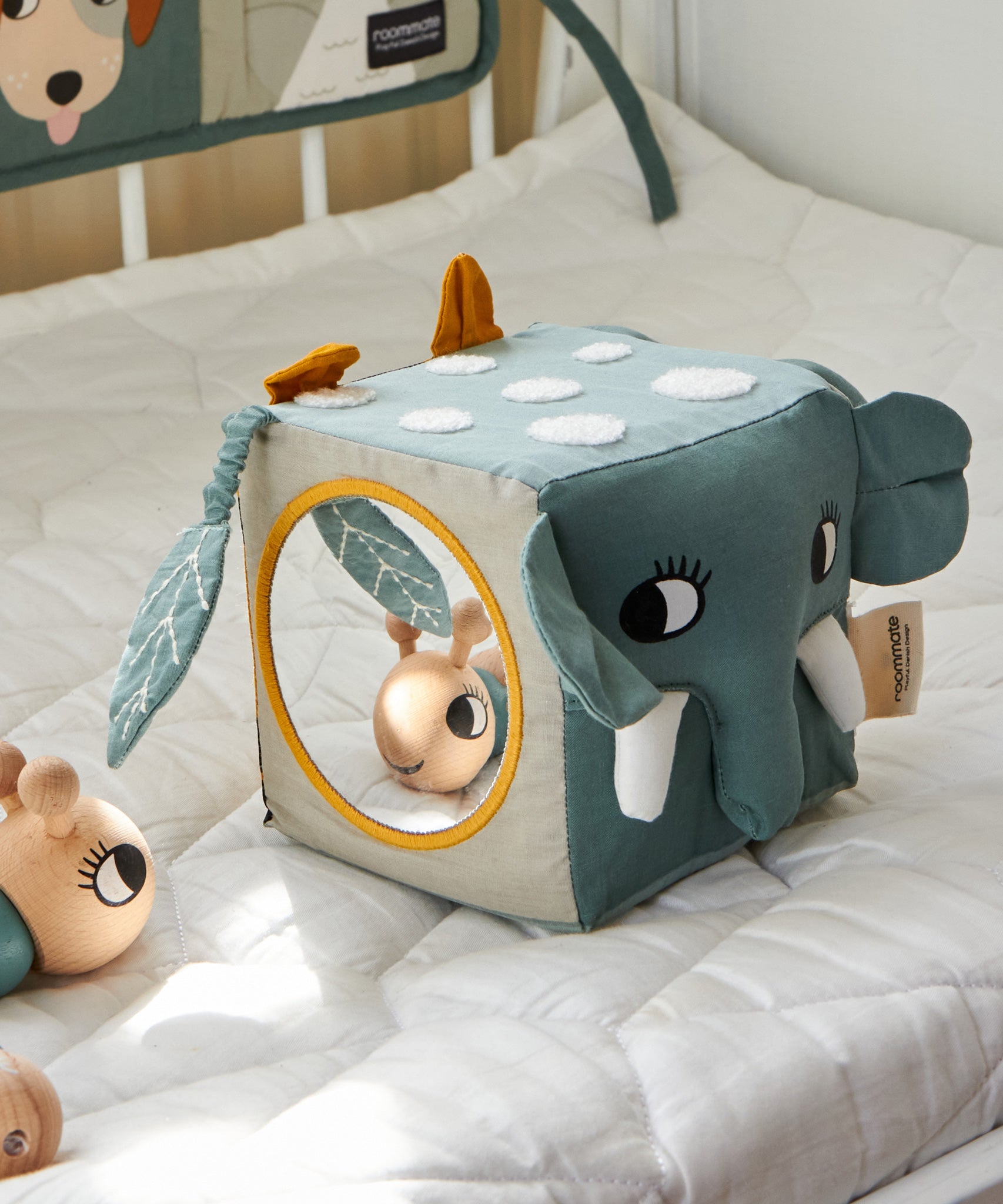 The Roommate Jungle animals soft Baby Activity Cube toy showing the side with the elephant face and the side with the mirror.