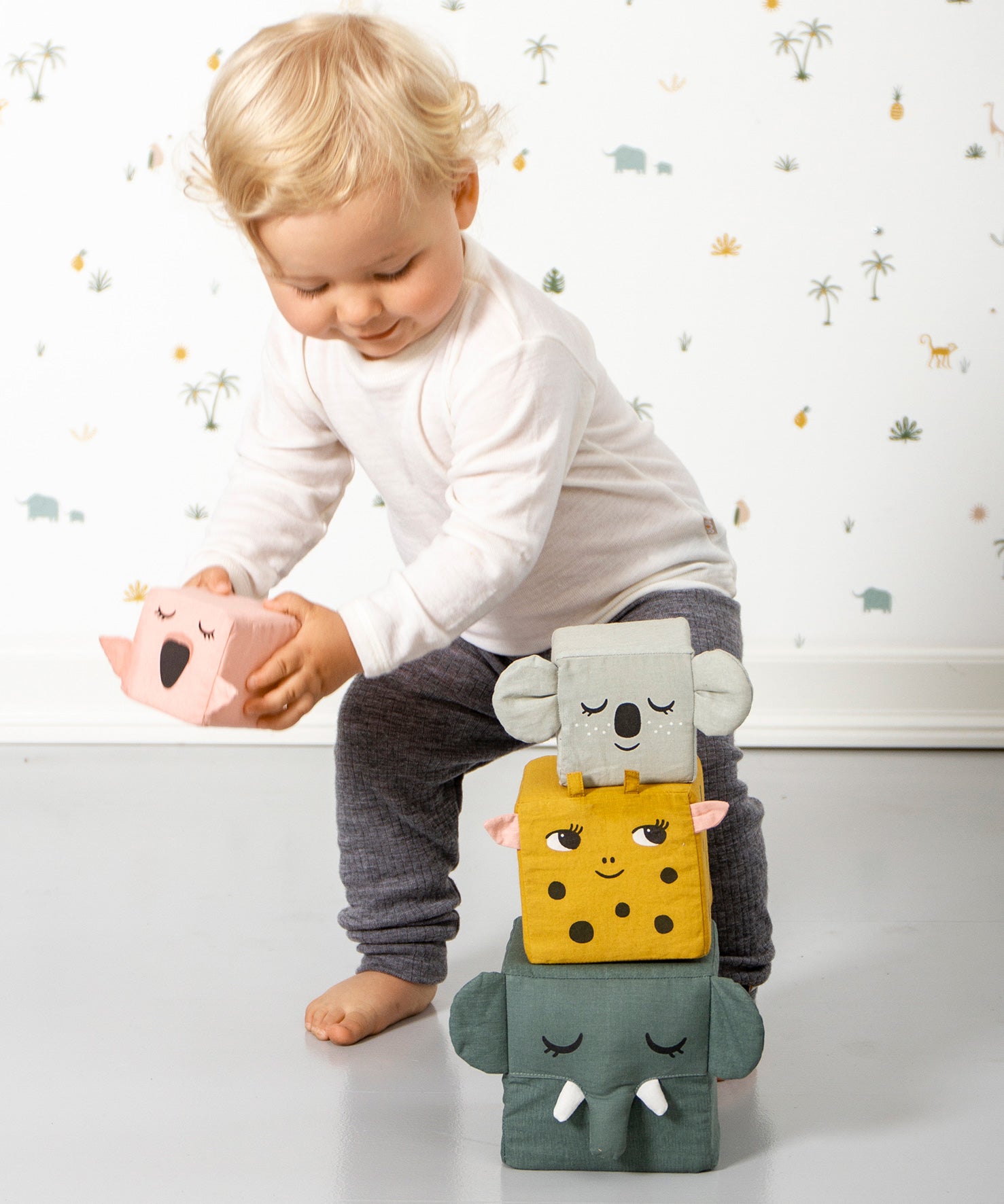 A child playing with the Roommate Jungle Life Stacking Blocks.