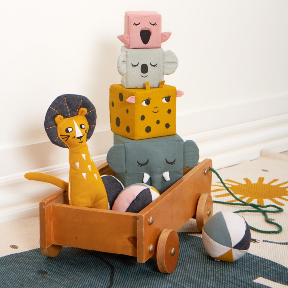 The Roommate Jungle Life Stacking Blocks, lion rag doll and fabric balls in a wooden cart.