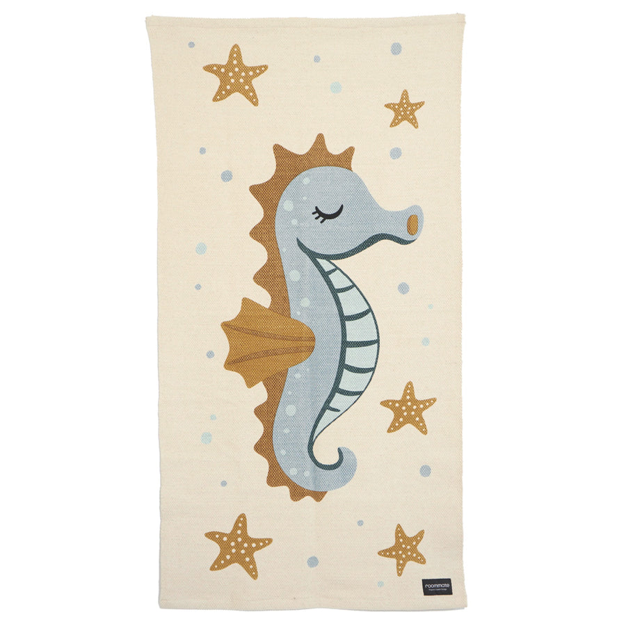 Roommate organic cotton seahorse print floor mat laid out on a white background