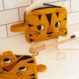 The Roommate kids Tiger washbag in a bathroom, filled with eco toiletries.