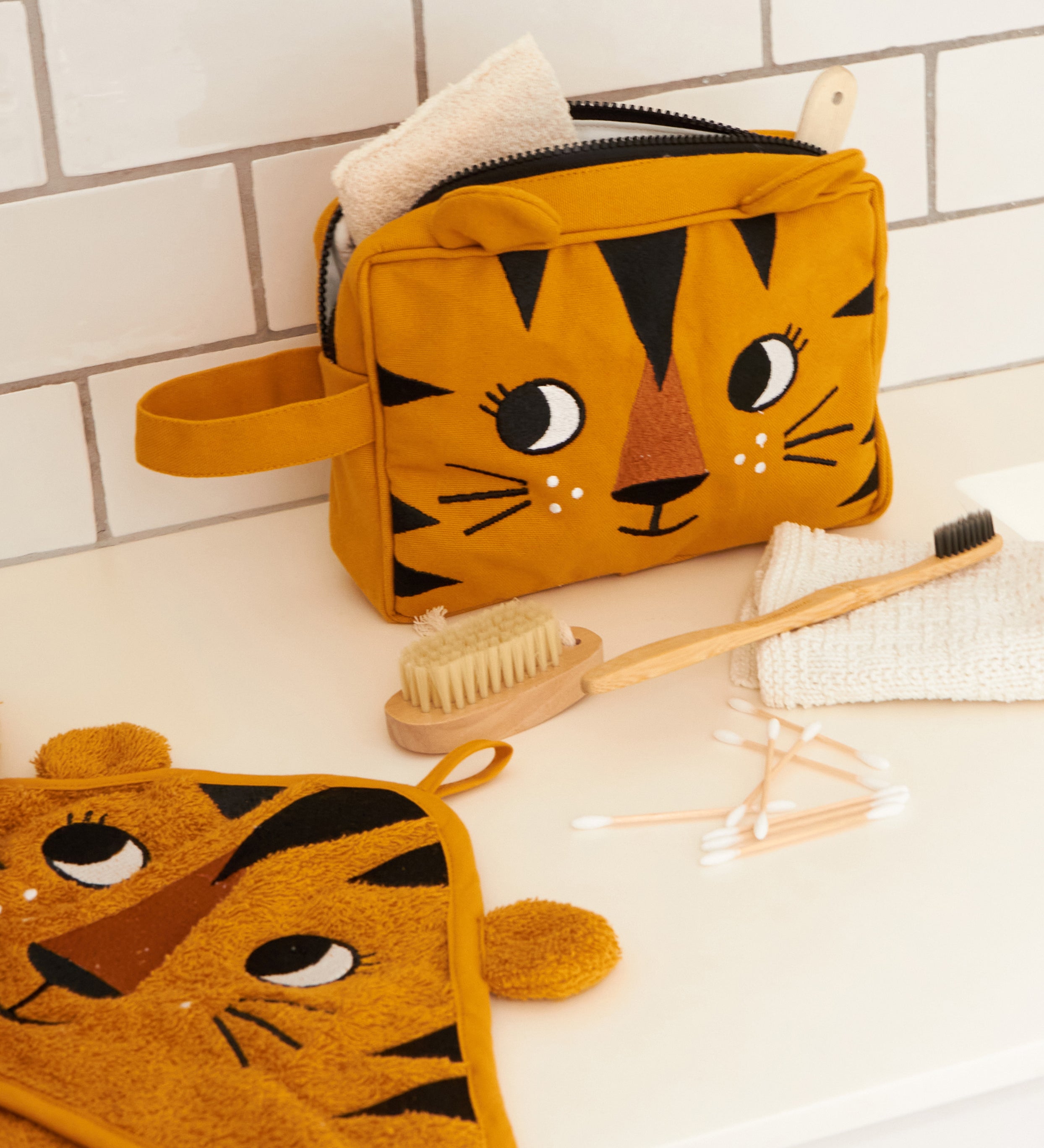 The Roommate kids Tiger washbag in a bathroom, filled with eco toiletries.