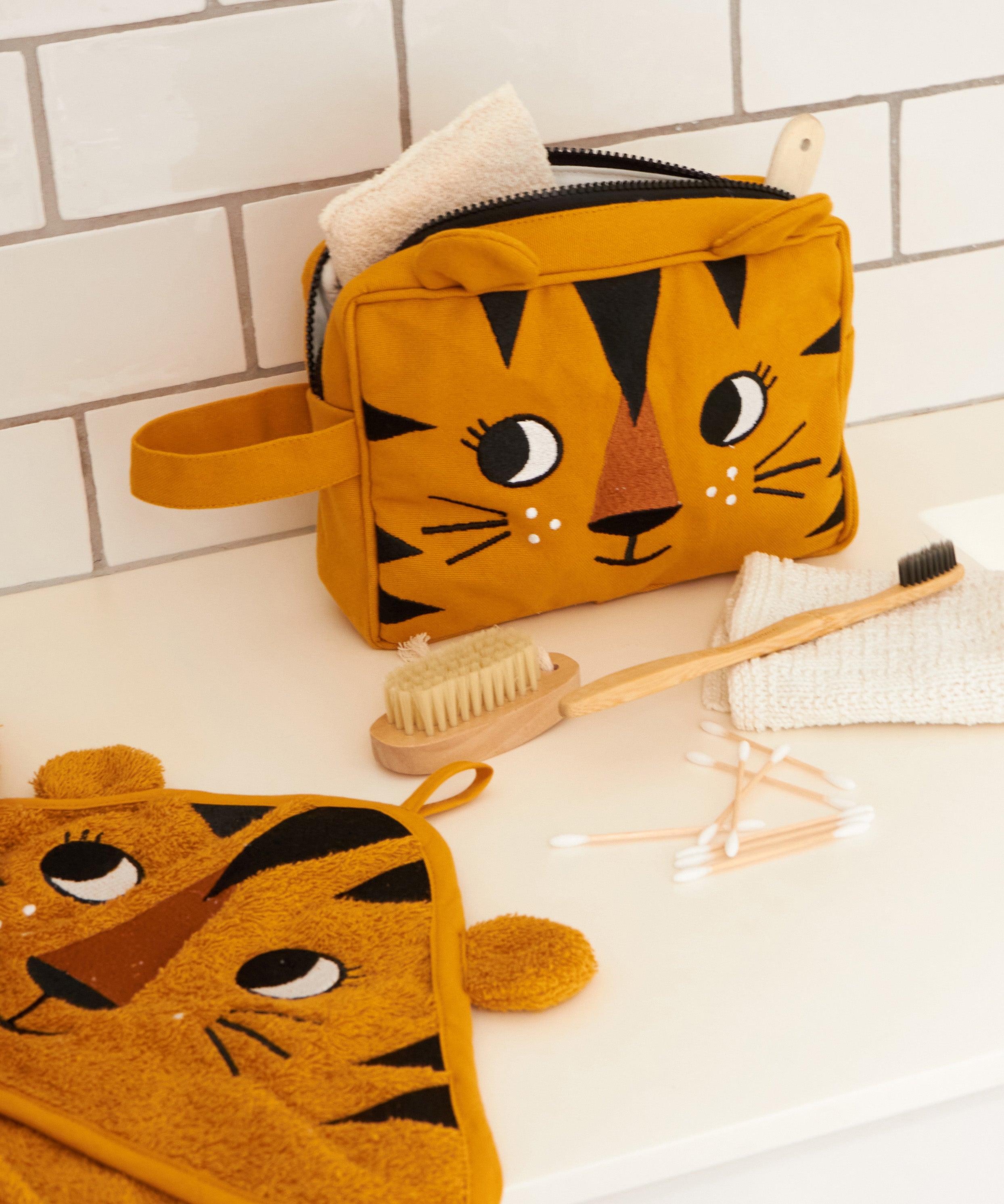 The Roommate kids Tiger washbag in a bathroom, filled with eco toiletries.