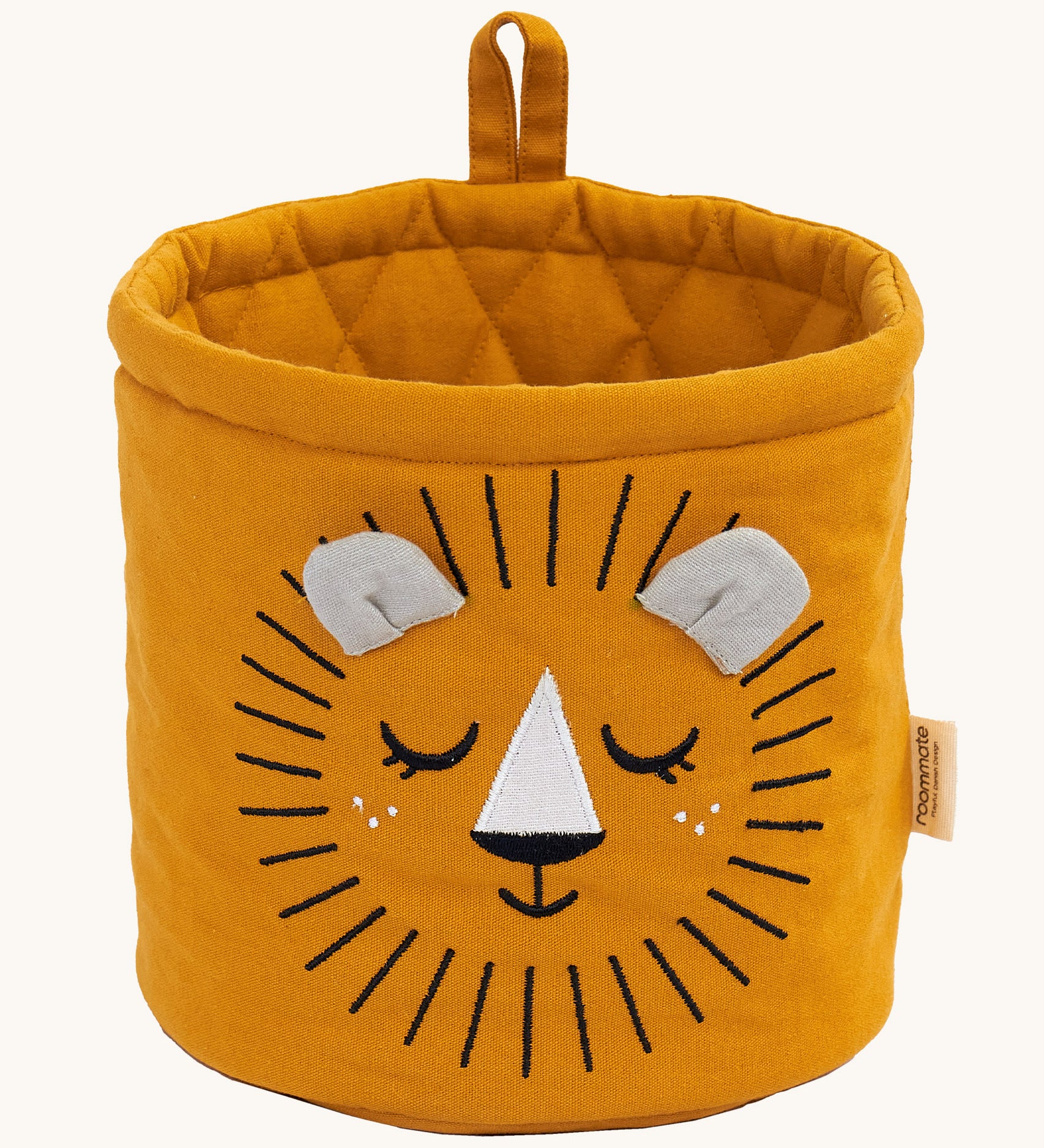 The Roommate Mini Quilted Basket - Lion in mustard yellow, with a sleepy embroidered face, and two small fabric ears in grey, and a mustard yellow hanging loop