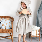 A child wearing the Roommate organic cotton bathrobe with a mouse design. 