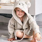 A child wearing the Roommate mouse bathrobe in a bedroom. 