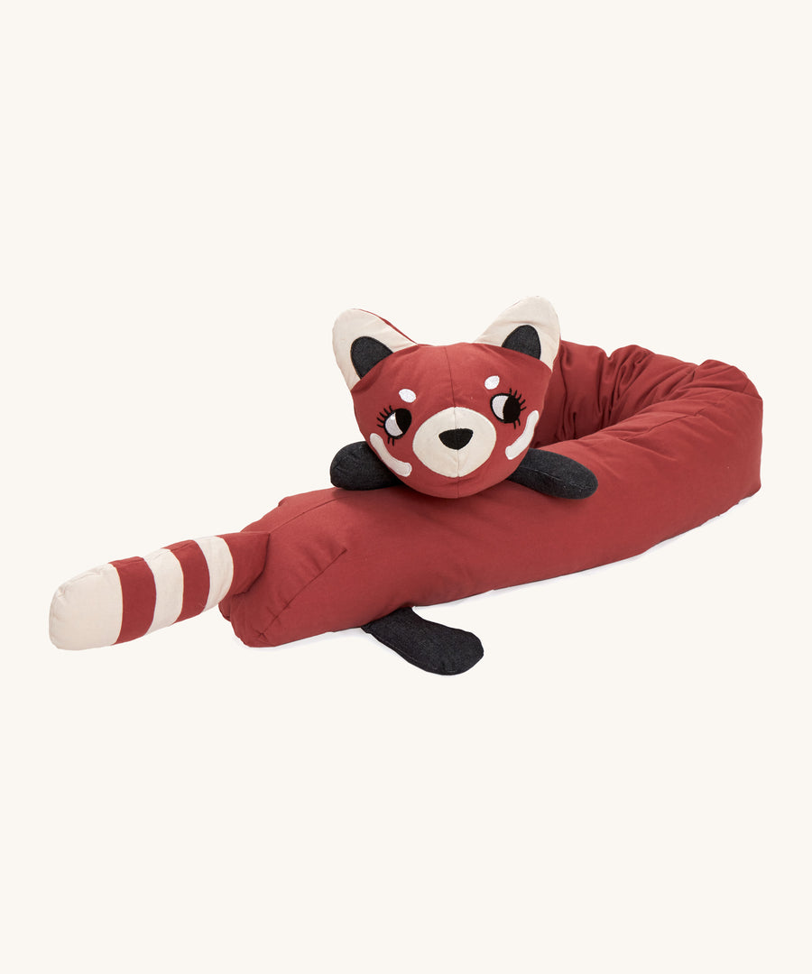 A Roommate red panda long cushion lied flaton a cream background