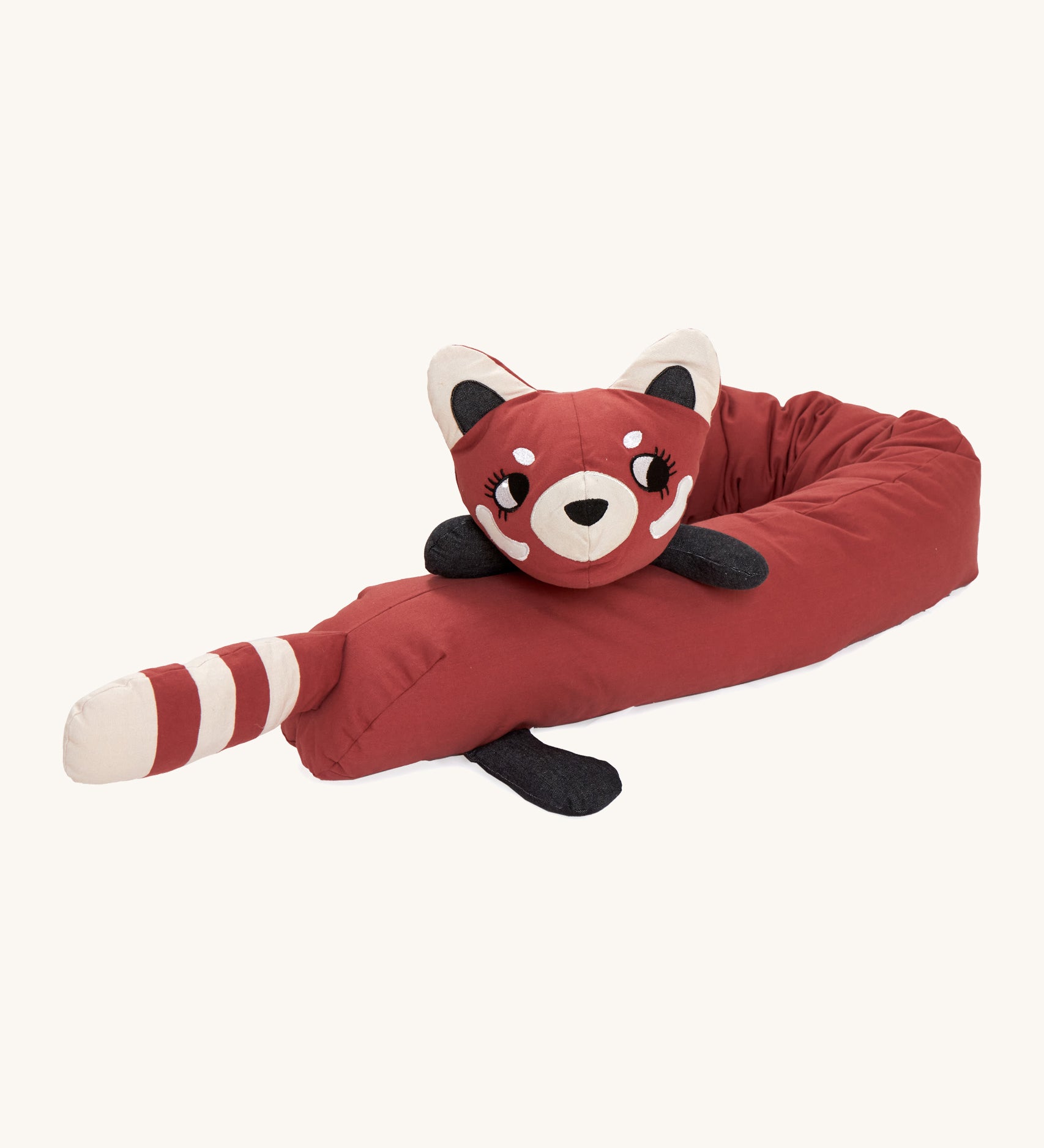 A Roommate red panda long cushion lied flaton a cream background