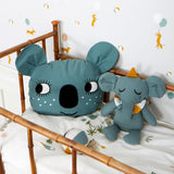 Roommate blue koala cushion and soft elephant toy on some white children's bedding