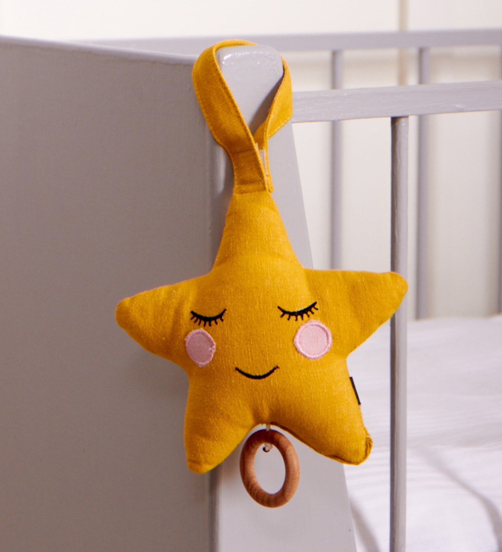 Roommate Star Lullaby Music Mobile hung on the end of a cot. 