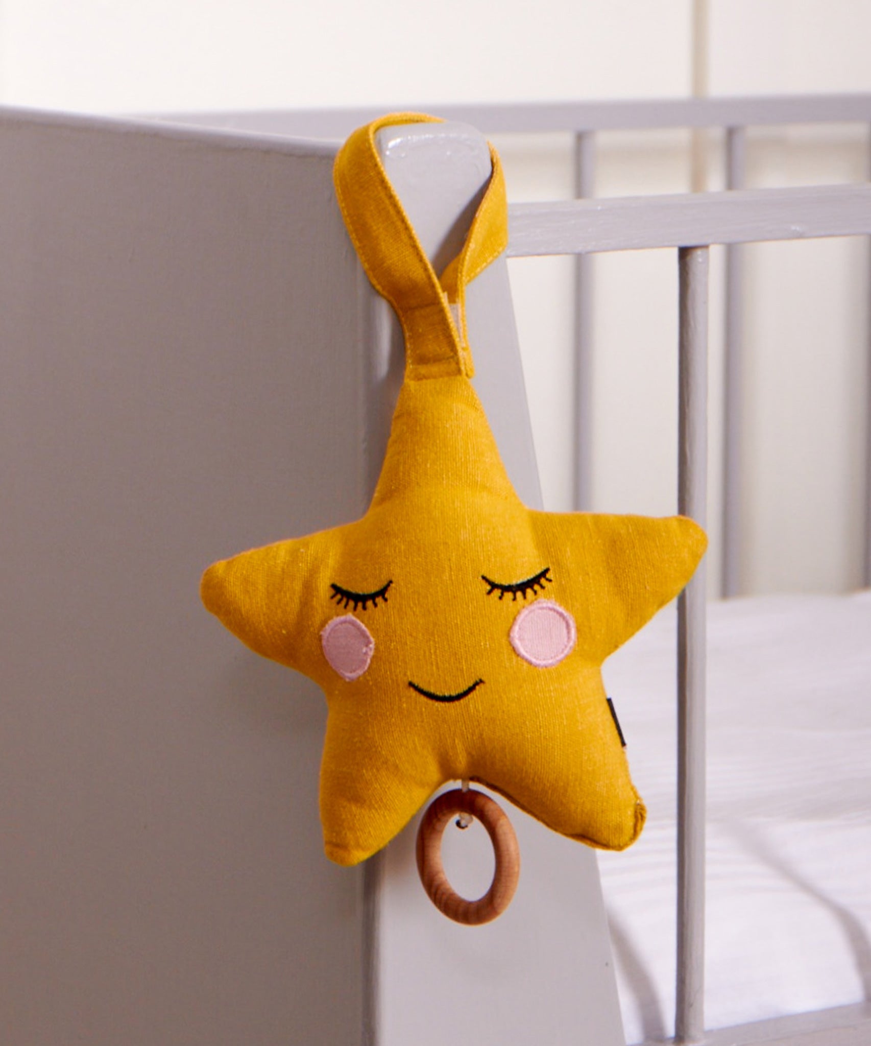 Roommate Star Lullaby Music Mobile hung on the end of a cot. 