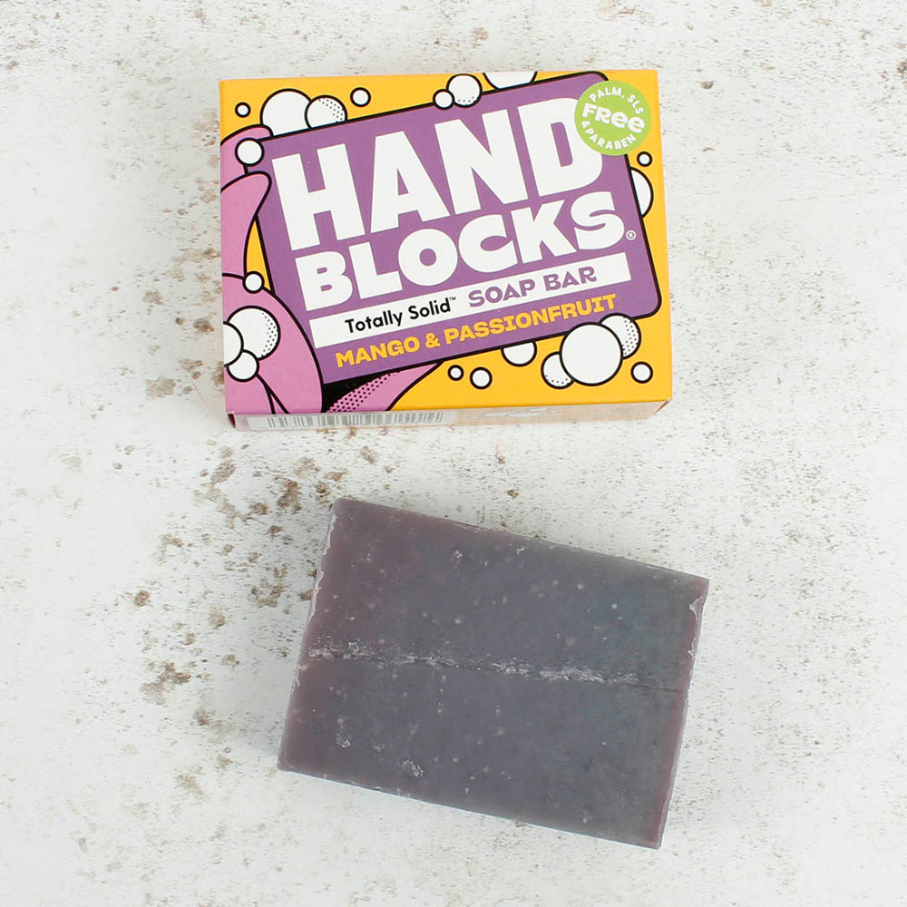 Hand Blocks purple Mango and Passionfruit soap bar and box on a white speckled back ground