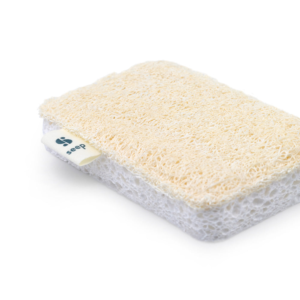 Close up of a Seep natural cellulose and loofah scourer on a white background