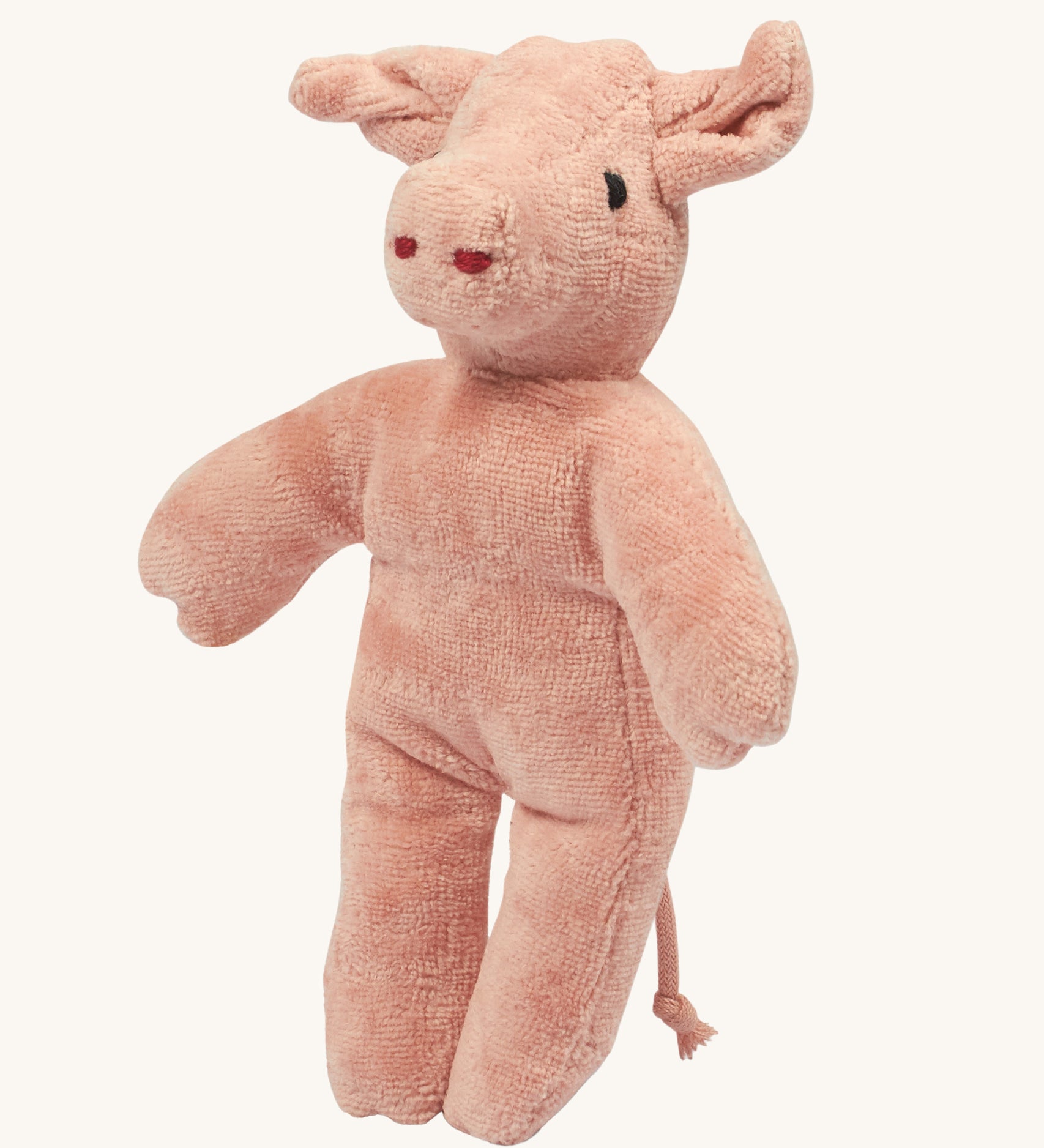 Senger baby pig stuffed animal on a plain background. 