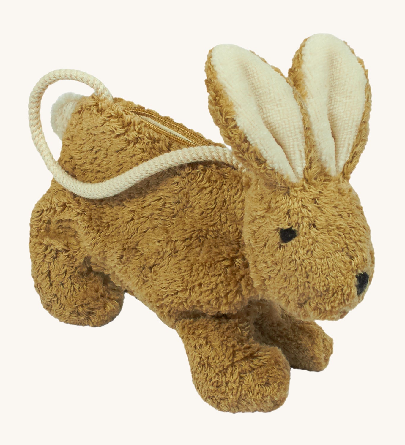 A Senger beige coloured rabbit bag on a plain background.