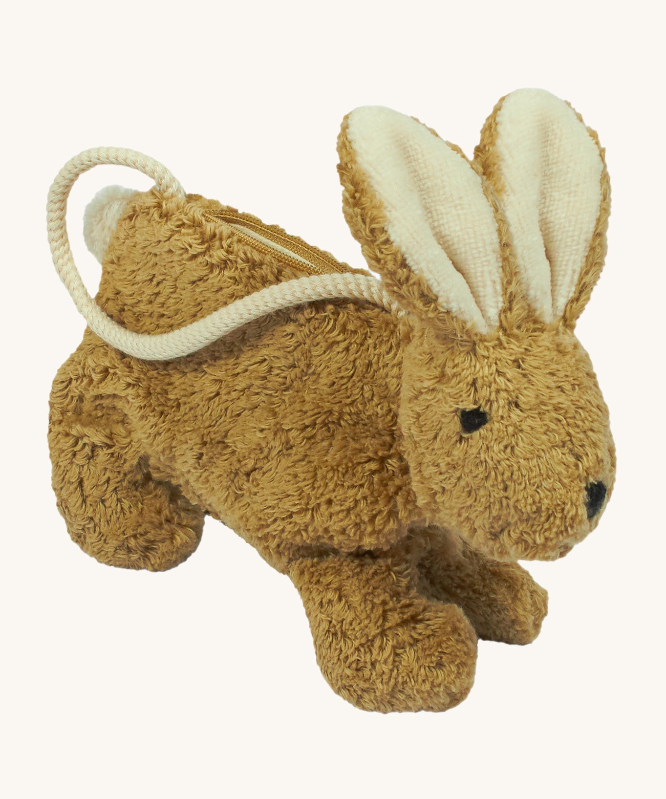 A Senger beige coloured rabbit bag on a plain background.