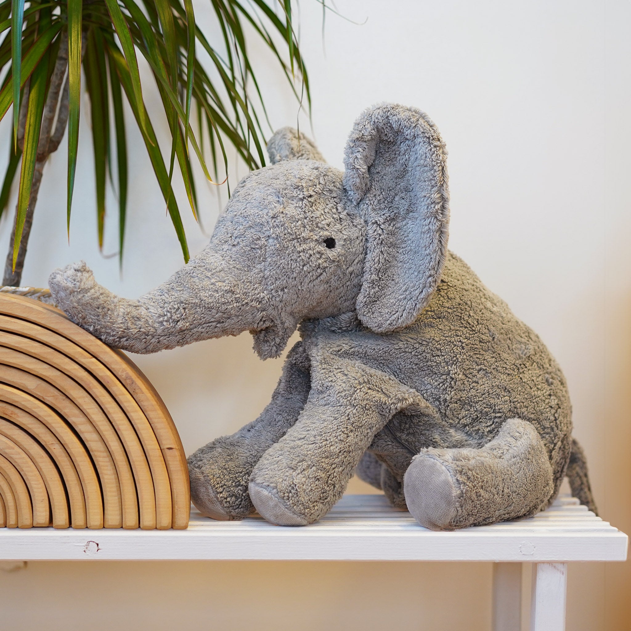 Senger Cuddly Animal Organic Soft Toy - Large Elephant. A cuddly Large Elephant soft toy by Senger with a soothing removable heat cushion inside filled with natural spelt chaff. Made from GOTS organic cotton with an organic cotton filling, on a cream back