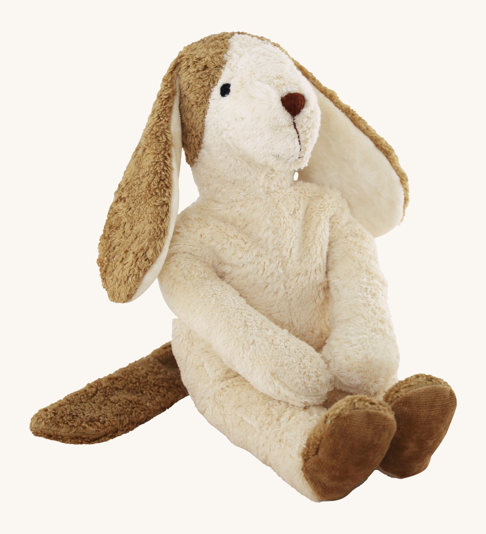 Senger large soft white dog teddy with brown floppy ears on a cream background.