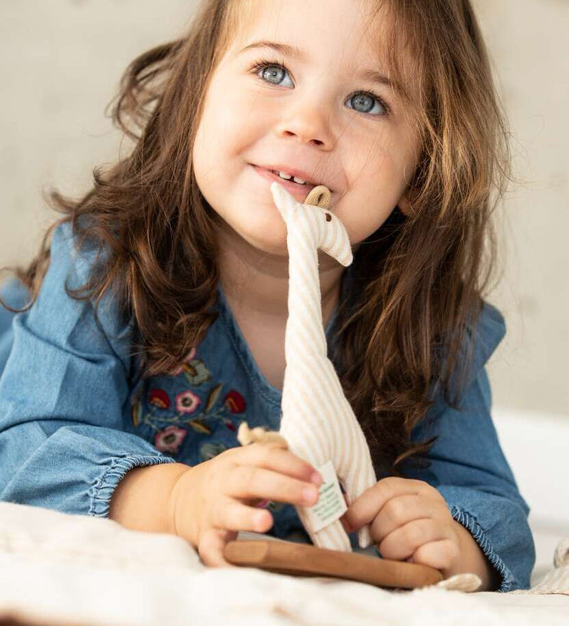 A child playing with the Senger Giraffe Grabber. 