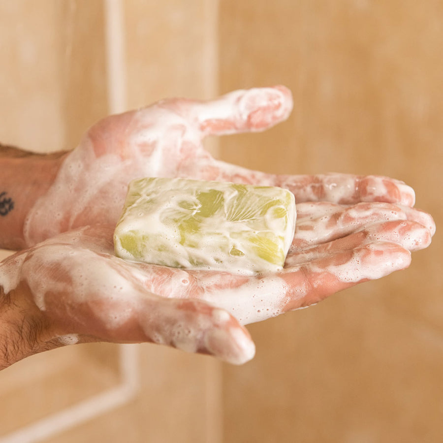 Shower blocks bar lathered up held in hands