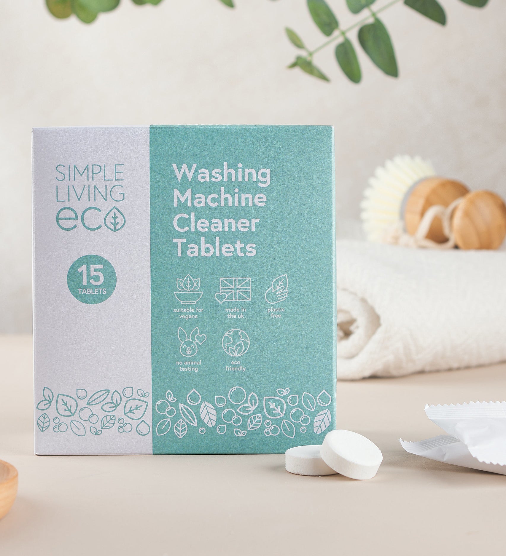 Simple Living Eco washing machine cleaner 15 pack tablets in original cardboard packaging resting on a table with 2 tablets 