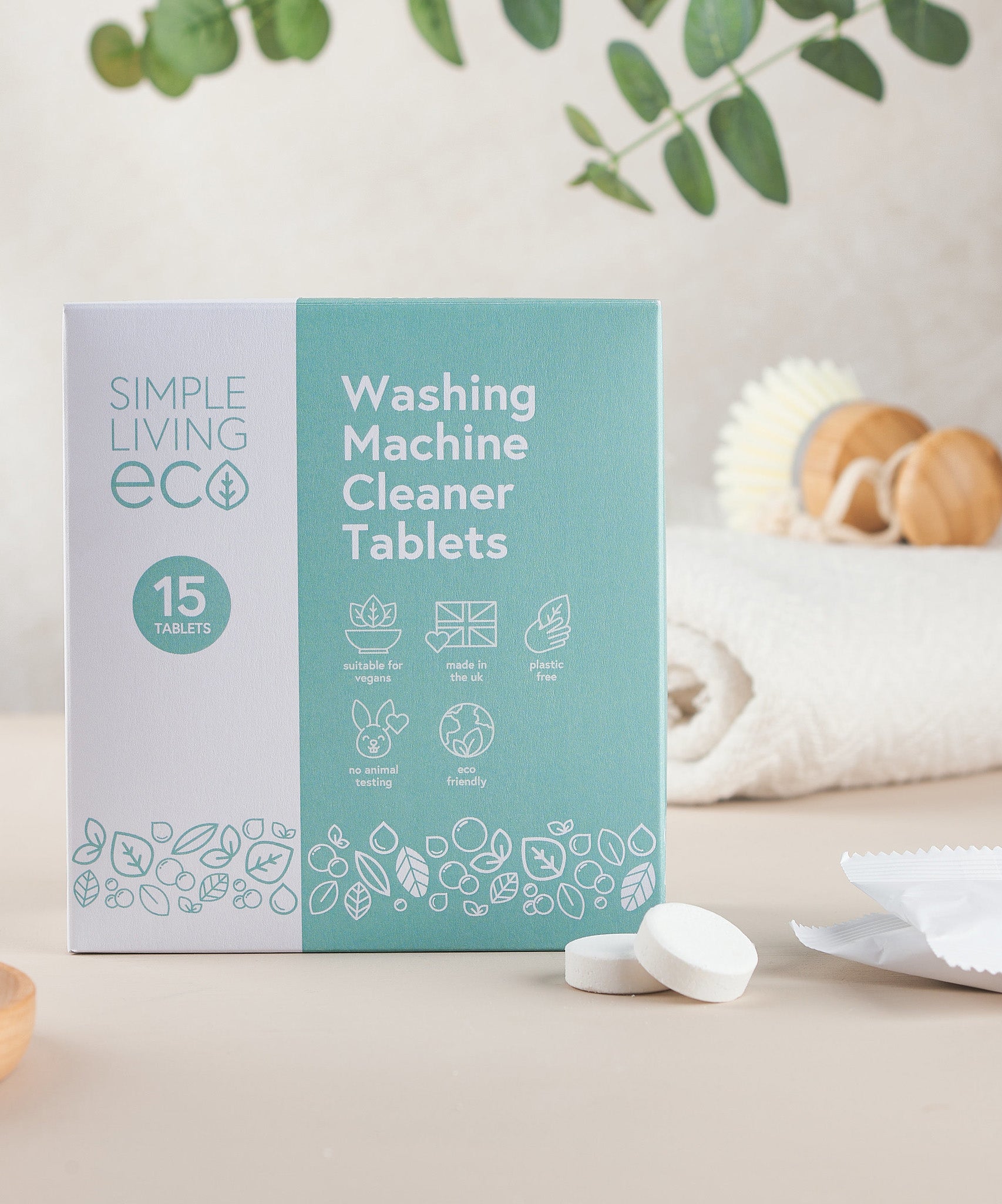 Simple Living Eco washing machine cleaner 15 pack tablets in original cardboard packaging resting on a table with 2 tablets 