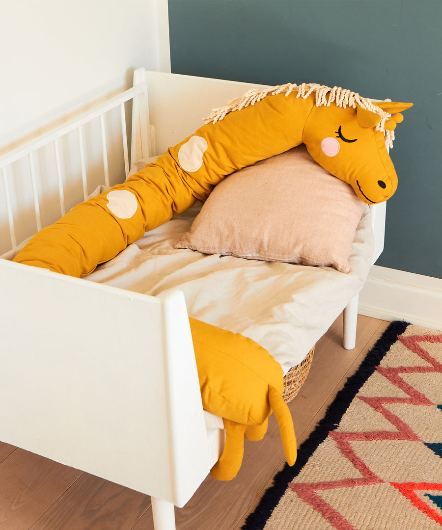  long giraffe cushion in mustard yellow with cream spots