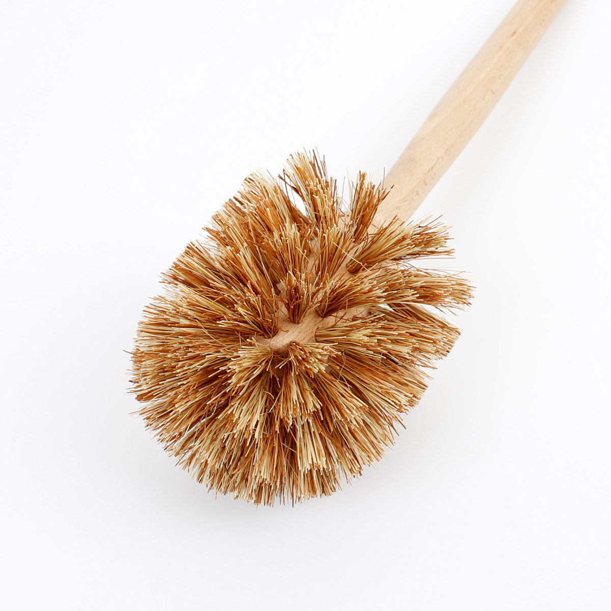 Close up of the A Slice of Green wooden toilet brush with plant-based bristles on a white background