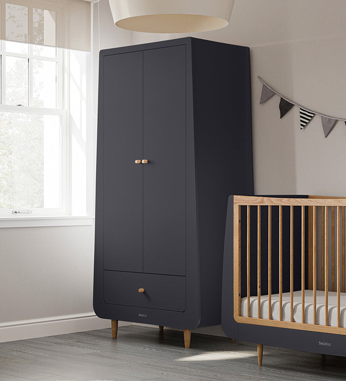 A slate SnuzKot Wardrobe pictured in a nursery placed next to a matching Snuzkot cot bed 