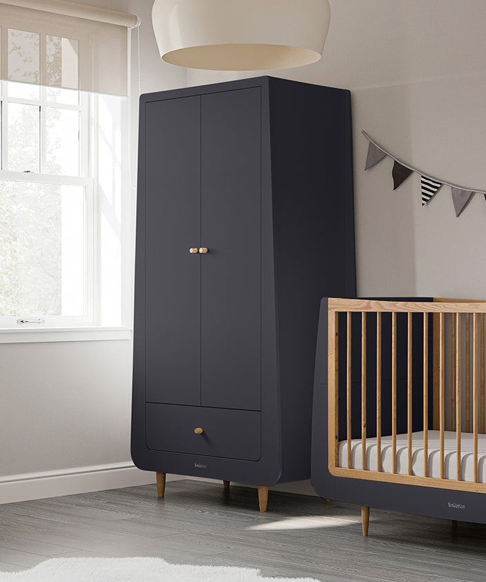 A slate SnuzKot Wardrobe pictured in a nursery placed next to a matching Snuzkot cot bed 