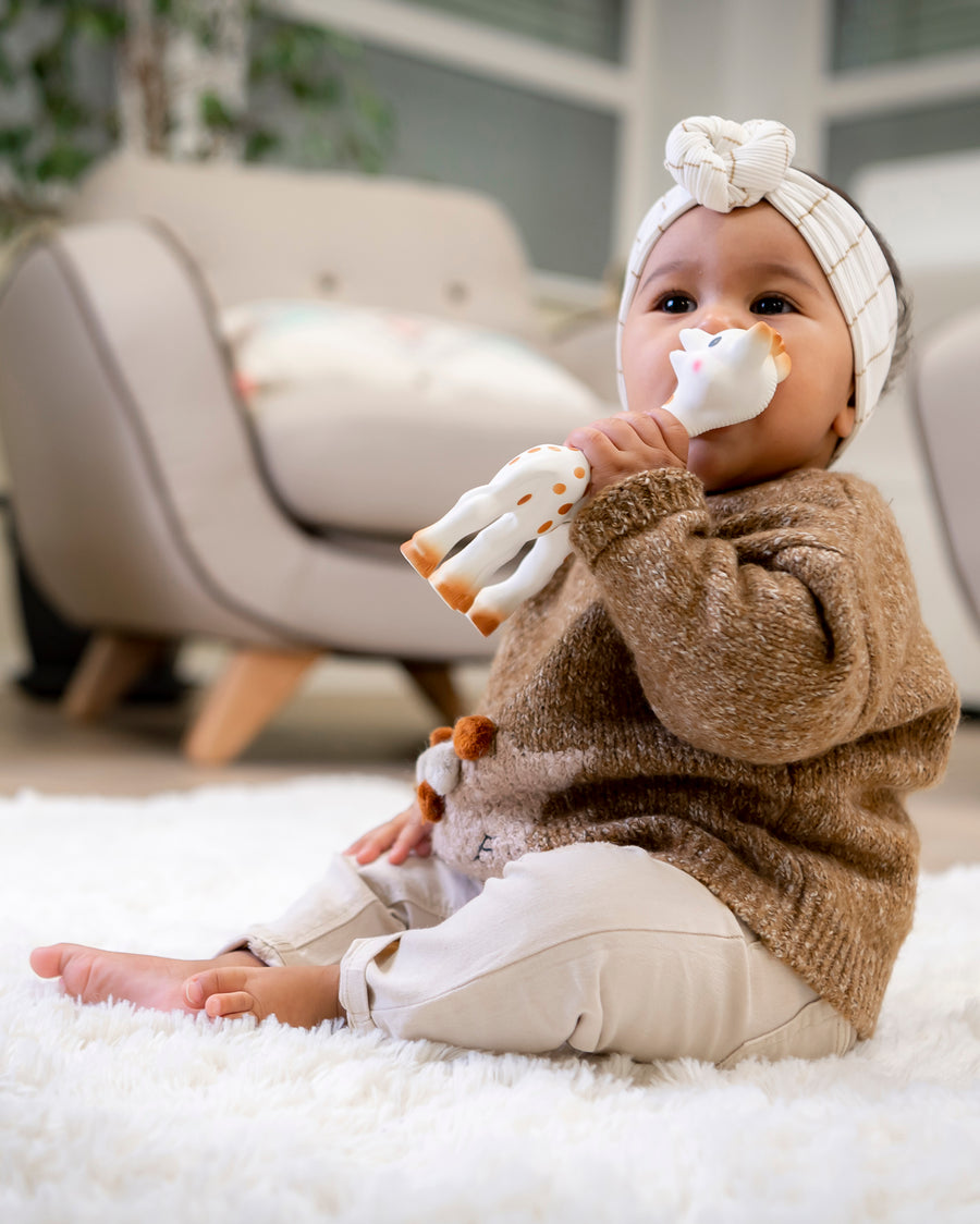 A child sat on a fluffy blanket