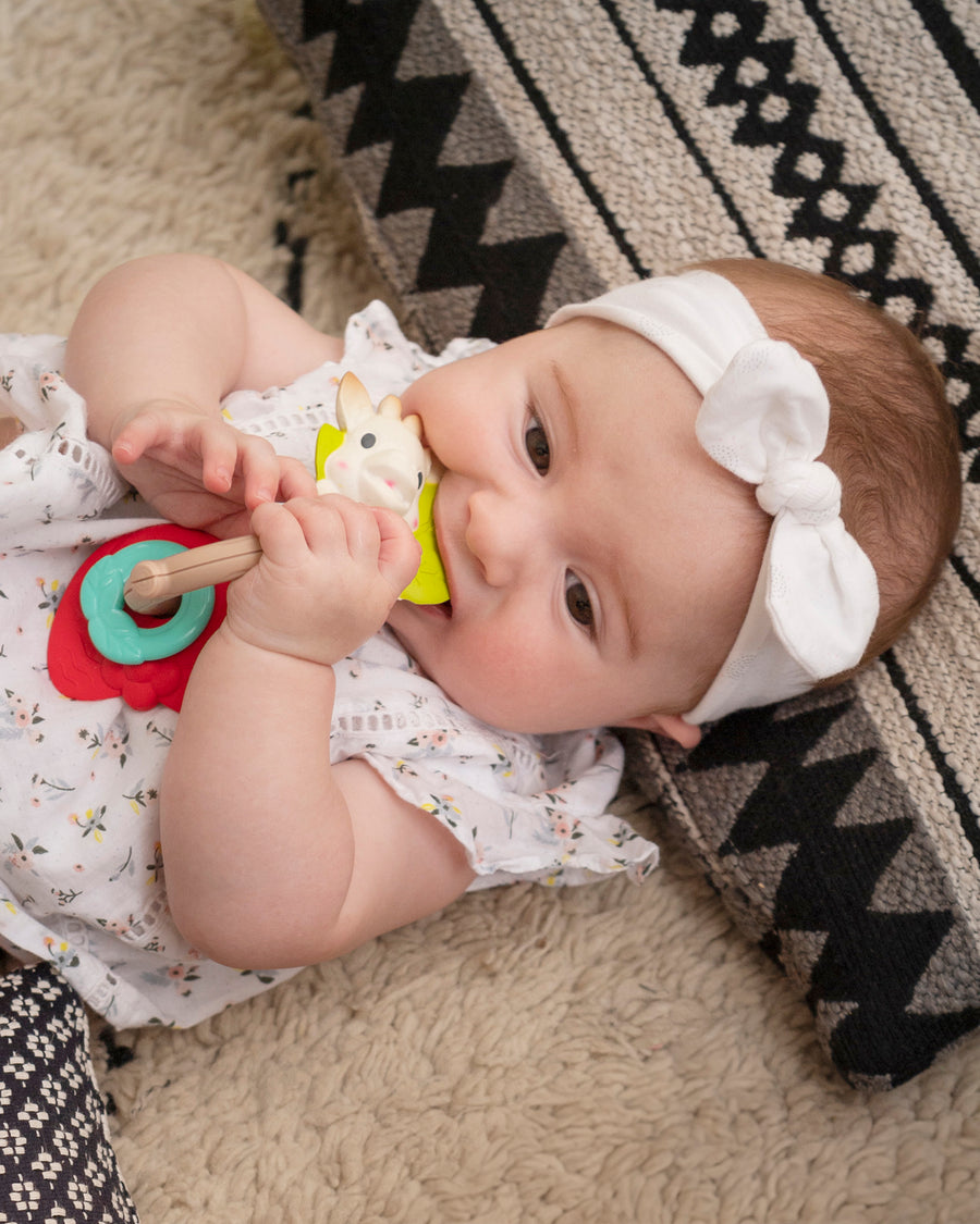  with a child chewing on the Sophie The Giraffe ring