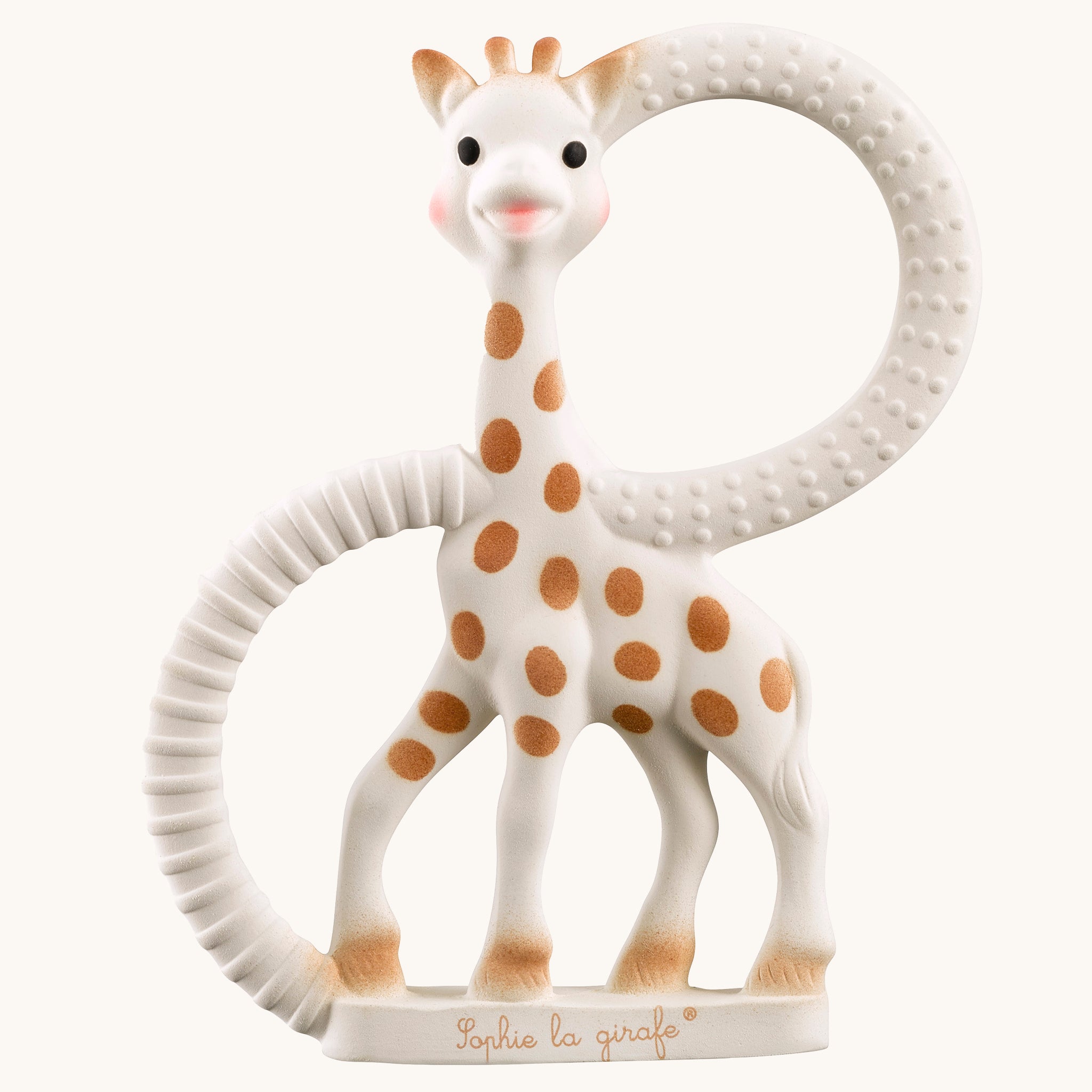 Sophie The Giraffe So Pure Soft Teething Ring. A natural rubber Sophie The Giraffe teether with two textured ring to soothe painful gums, on a cream background 