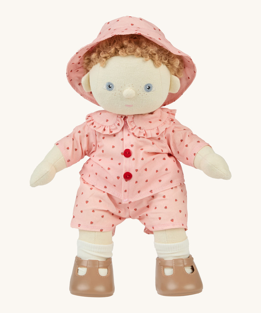 An Olli Ella dinkum doll wearing the pink strawberry outfit