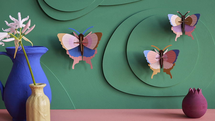 Studio Roof cardboard 3D butterfly ornaments on a wall