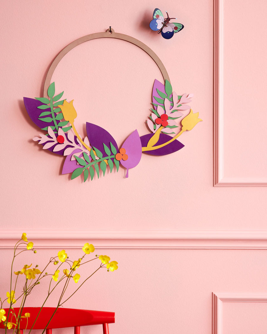 Studio roof blossom wreath pop out card decoration hanging from a pink wall