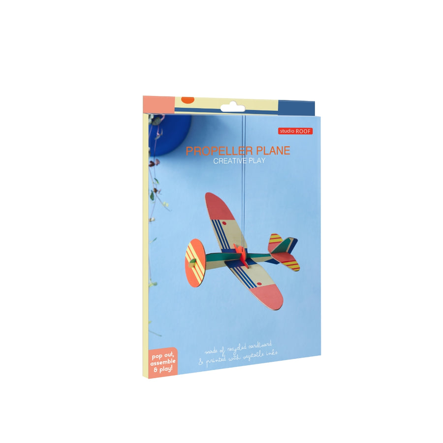 a cardboard model plane with geometric patterns and bright colours