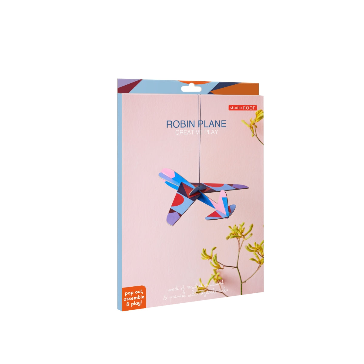 a cardboard model plane with geometric patterns and bright colours