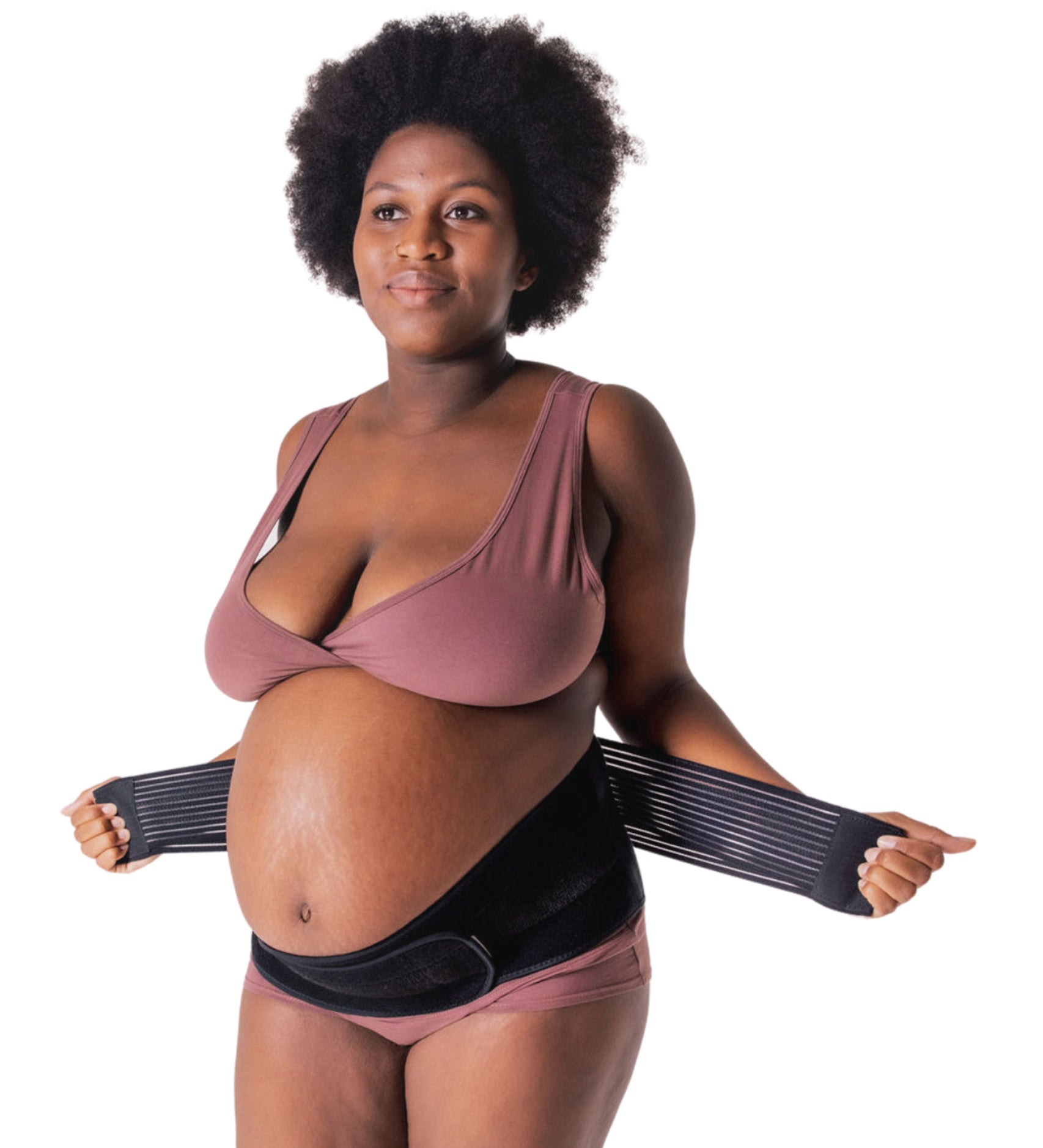 A person showing how to put on the Lola & Lykke Core Relief Pregnancy Support Belt