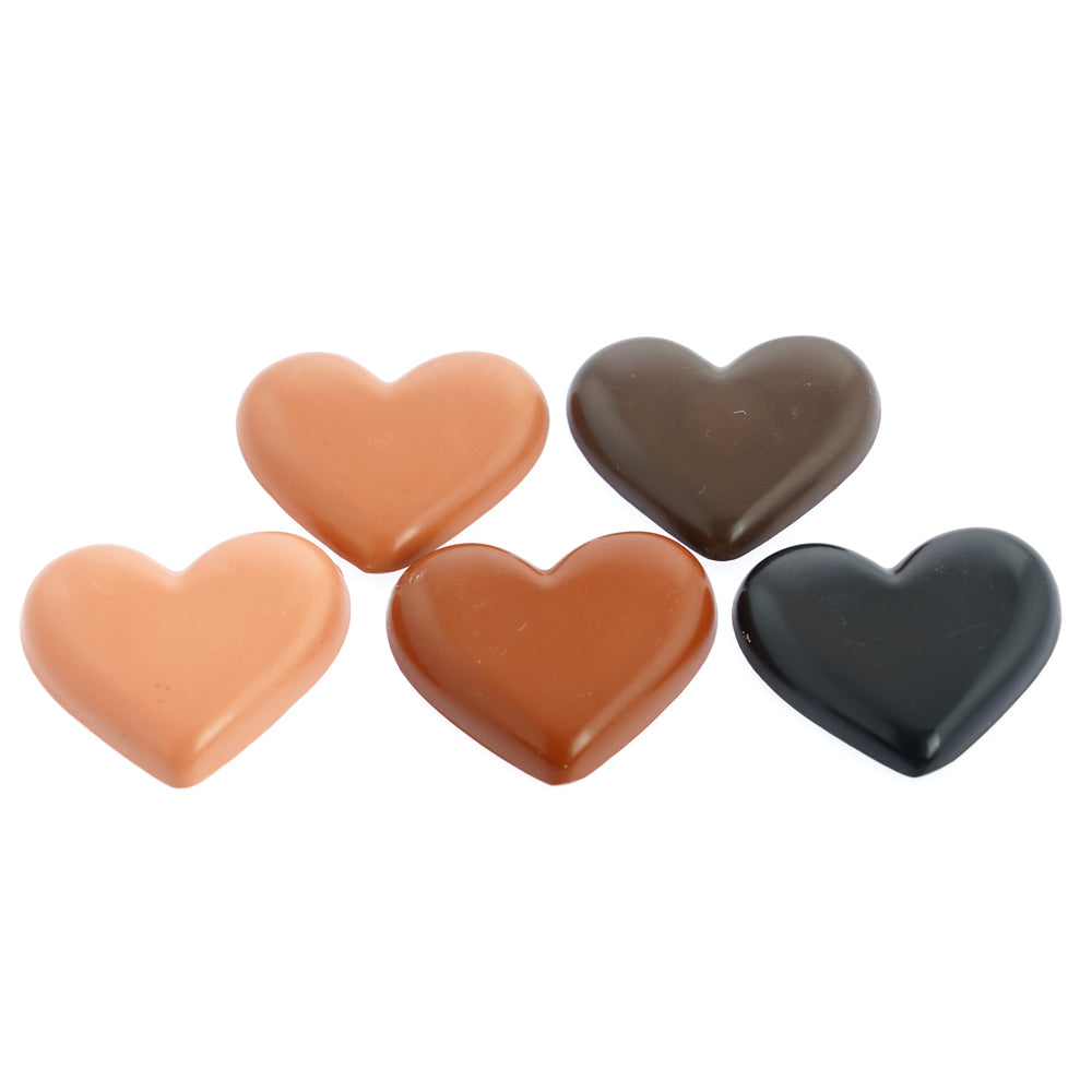 The crayon bug handmade coloured skin tone heart crayons laid out on a white background