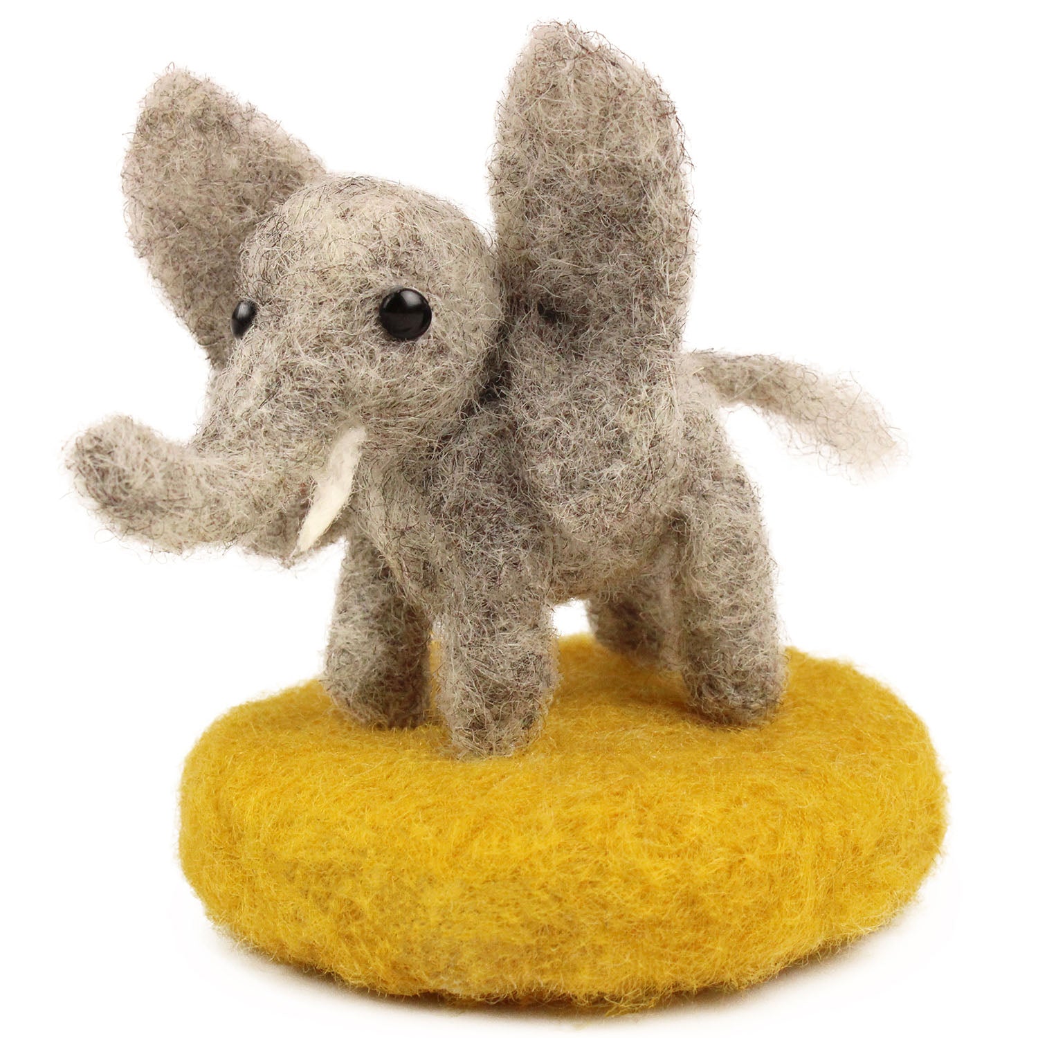 A fully made The Makerss - Amiguwoolli Tiny Elephant Mini Needle Felt Figure. The Elephant is made from grey woolen felt with white tusks