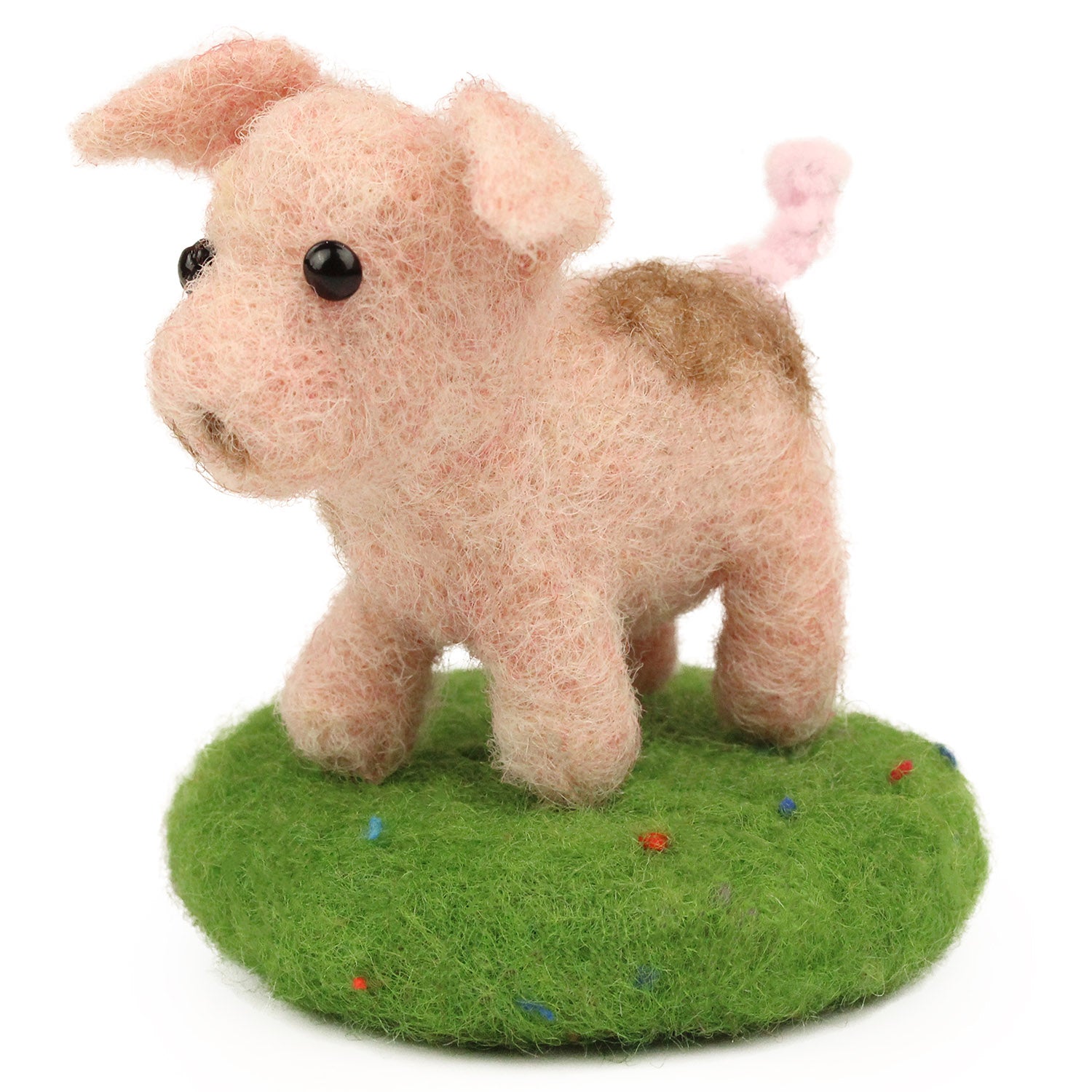 A fully made The Makerss - Amiguwoolli Tiny Pig Mini Needle Felt Figure. The pig is made from pink woolen felt