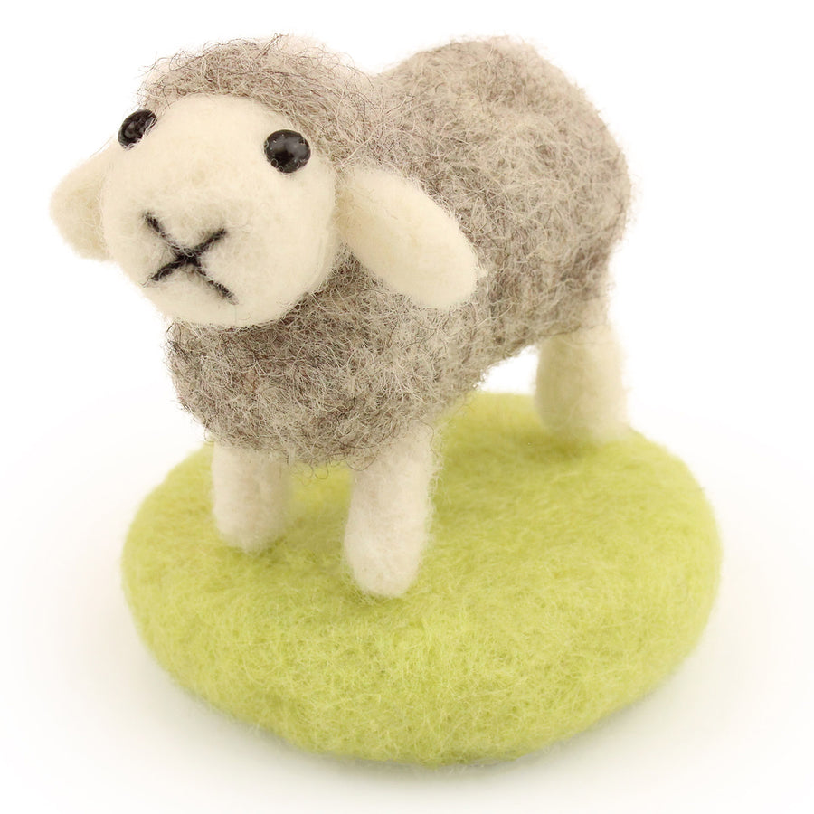 A fully made The Makerss - Amiguwoolli Tiny Chicken Mini Needle Felt Figure. The sheep is made from grey woolen felt