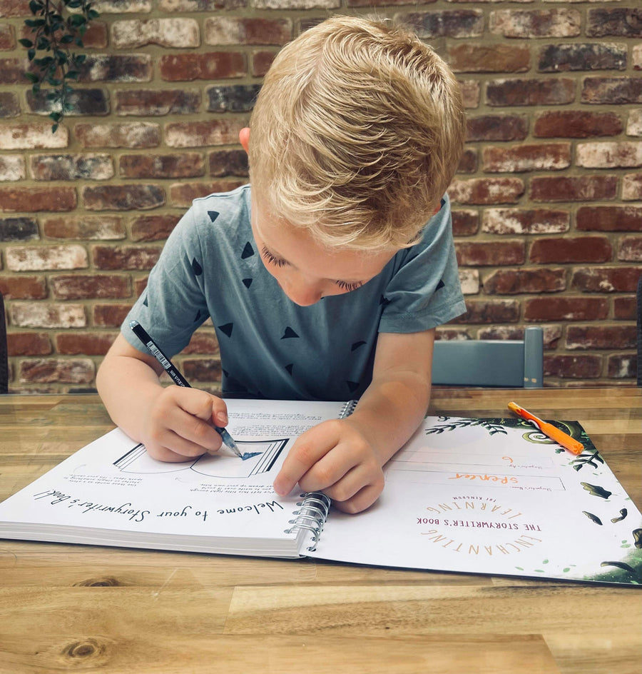 A child holding the The Phive Enchanting Learning Storywriter's Book - The Kingdom