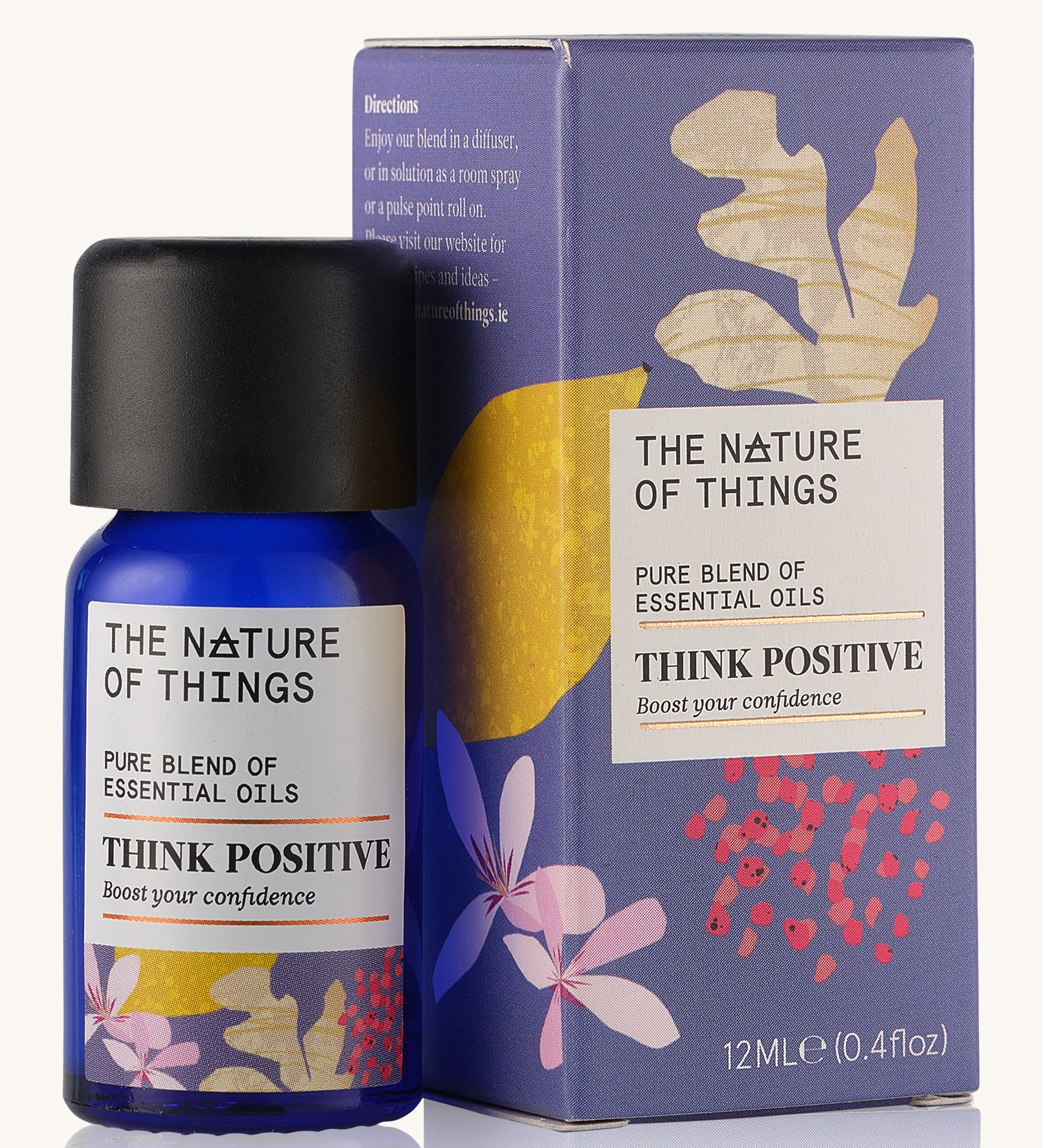 Think Positive pure essential oil blend in a blue glass bottle in front of a decorative purple cardboard box.