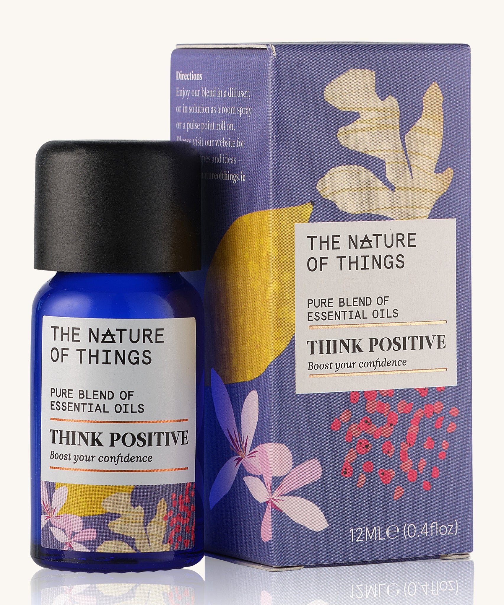 Think Positive pure essential oil blend in a blue glass bottle in front of a decorative purple cardboard box.