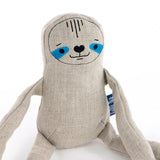 Close up of the Tobe hempions sloth toy on a white background