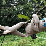 Tobe hempions soft sloth rag doll hanging from a tree branch