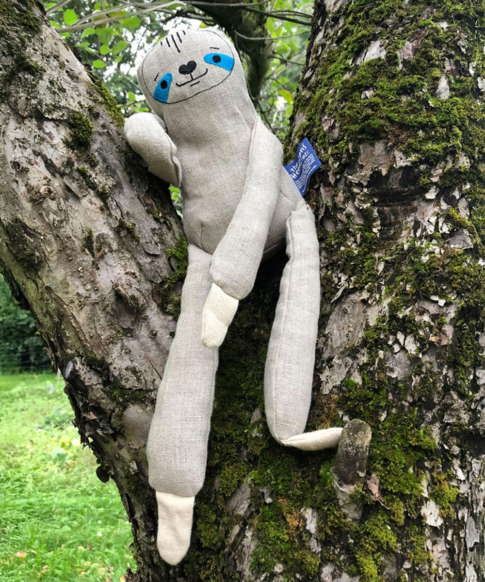 The Tobe The Hempions sloth toy placed on a tree. 